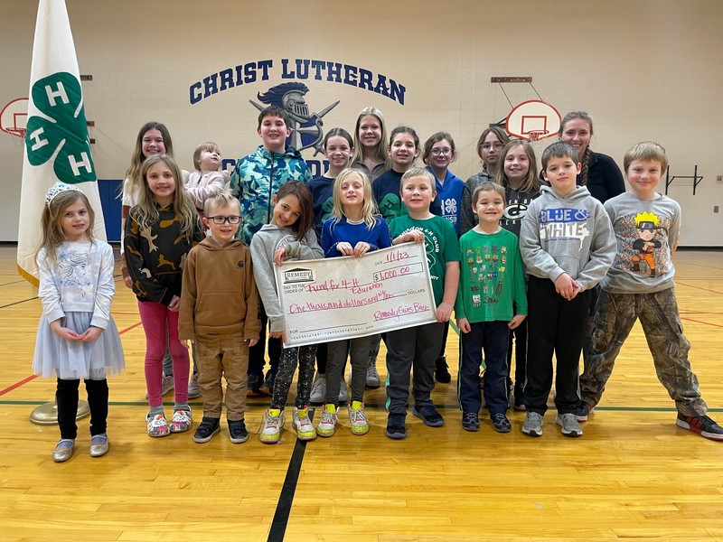 Lowerr Family of Remedy Consulting presenting check to Fund for 4-H Education in Waukesha, WI in 2022. Members of Washington 4-H Club (Big Bend, WI) held the check in this photo.