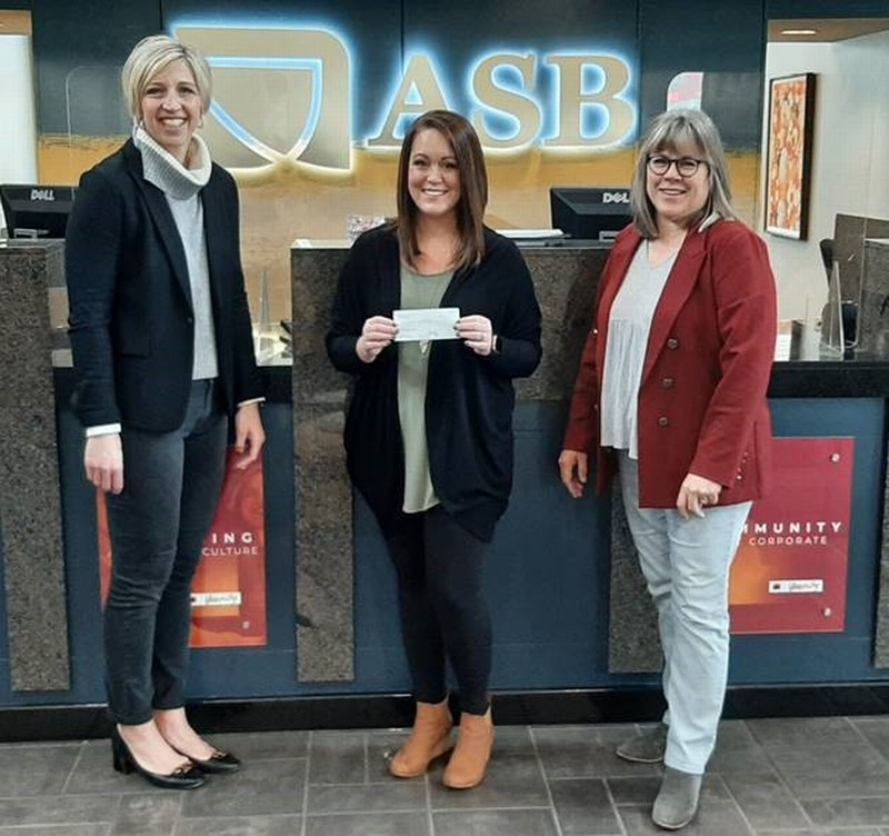 Abi Griffin, CFO of Andover State Bank (KS), presenting check to Jamee Crenshaw, Director of Development for Sunlight Children’s Services, and Mary Huelskamp, Executive Administrative Assistant of Andover State Bank in Andover, KS.