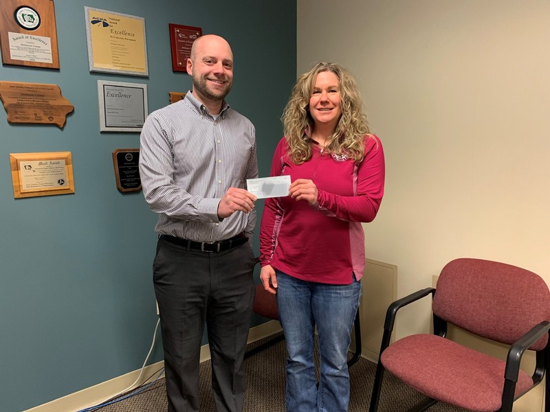 The State Bank (IA)'s President, Andy Schultz, presenting the check to Erin Reed representing the Dickinson County Trails in Spirit Lake, IA.