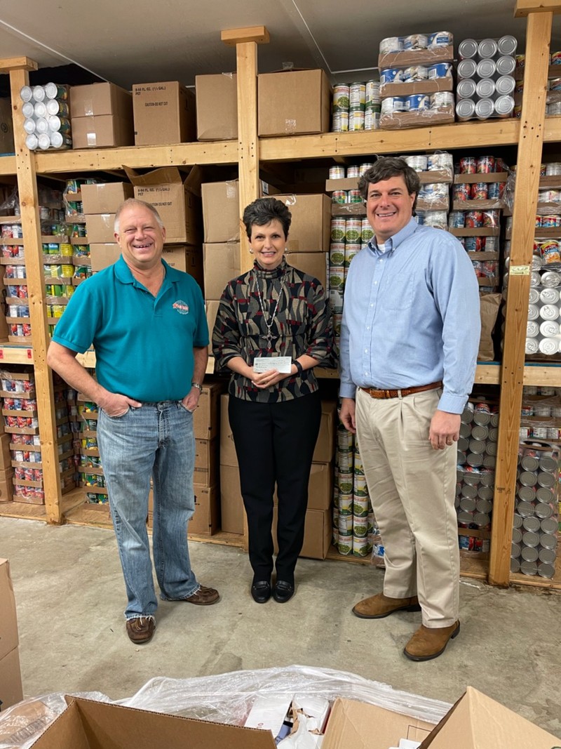 Walker Jordan, President and CEO of Bank of Monticello, presenting check to Kim McMichael, Jasper County Food Bank Board Member, and Ken Horton, Director, Jasper County Food Bank in Monticello, GA.