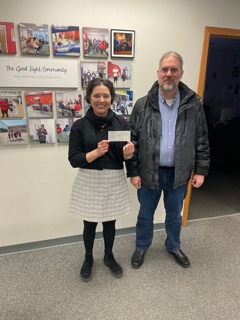 Brian Spreuer, CEO of River Bank, presented the check to Amanda Worman Holmgaard, Executive Director of The Good Fight Community in January 2025.