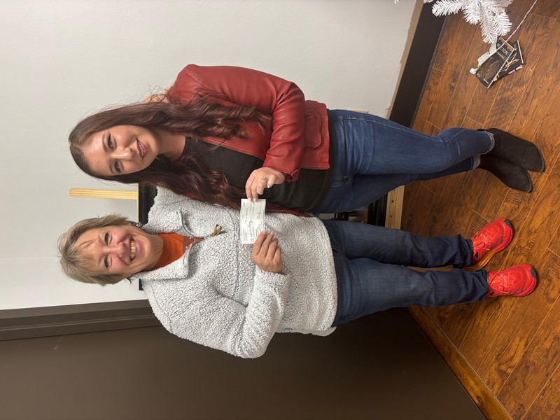 Tina Gillihan of Permian Basin Dream Center for Orphans received the check from Wende Parsley (representing West Texas National Bank) in December 2024.