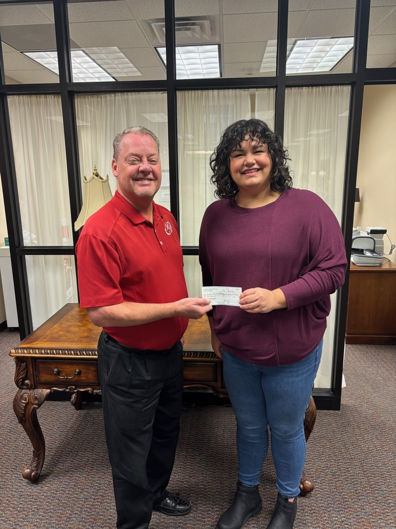 Mike Rittenberry, President & CEO of PBOMT presented check to Morgan Bargers with the First Choice Pregnancy Counseling Center in December 2024.